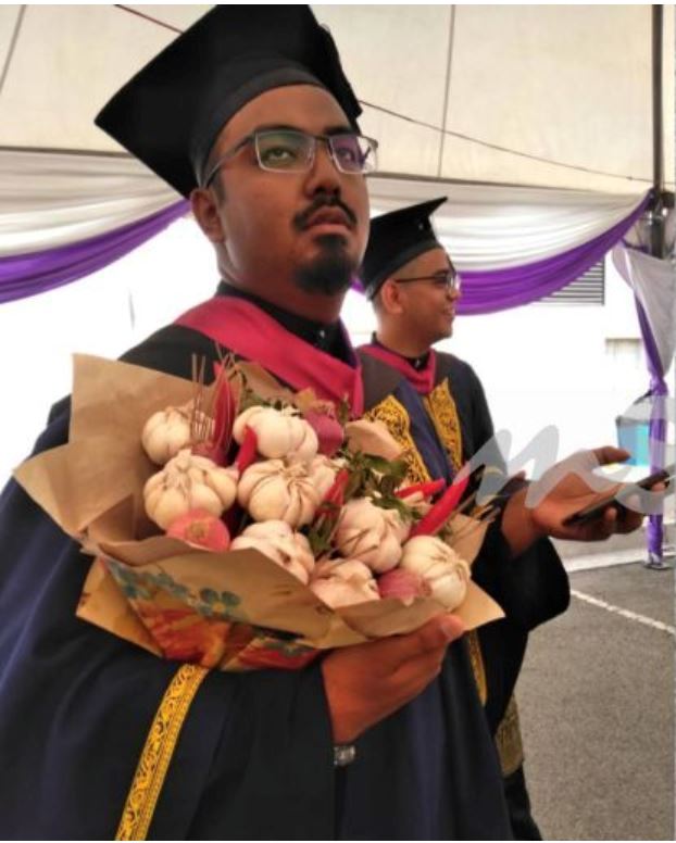 this guy received a bouquet of garlic for his graduation because he loves to ‘membawang’!