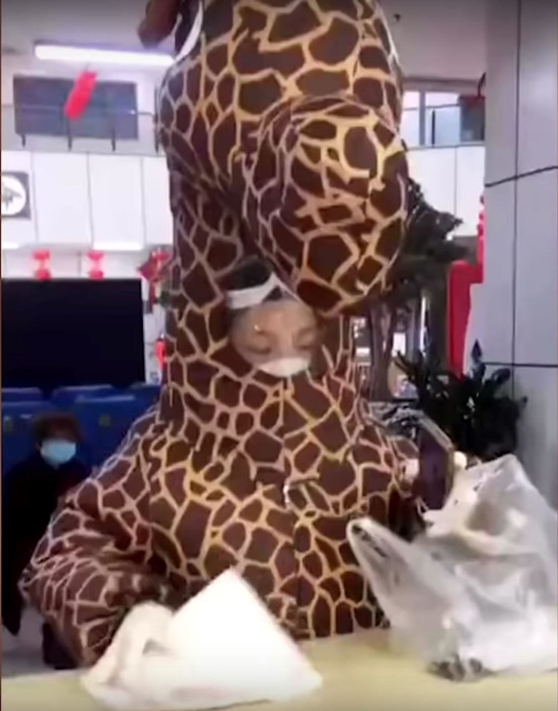 chinese woman turns up at hospital in inflatable giraffe costume as protection from covid-19