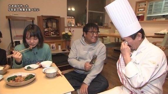 family cries as they eat their mother