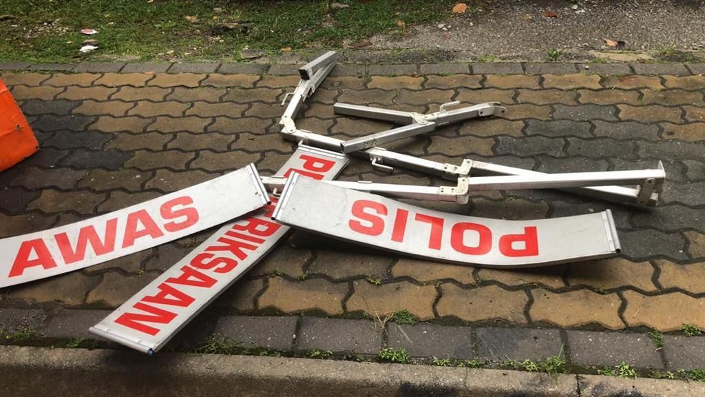 man crashes into police roadblock while distracted on phone 